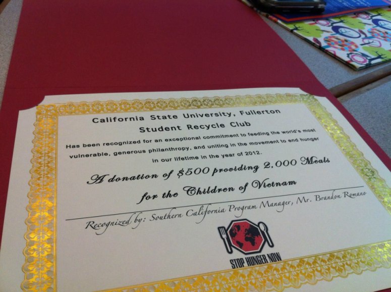 SCR's Representative giving donation check to Brandon Romano (Southern California Program Manager Stop Hunger Now)